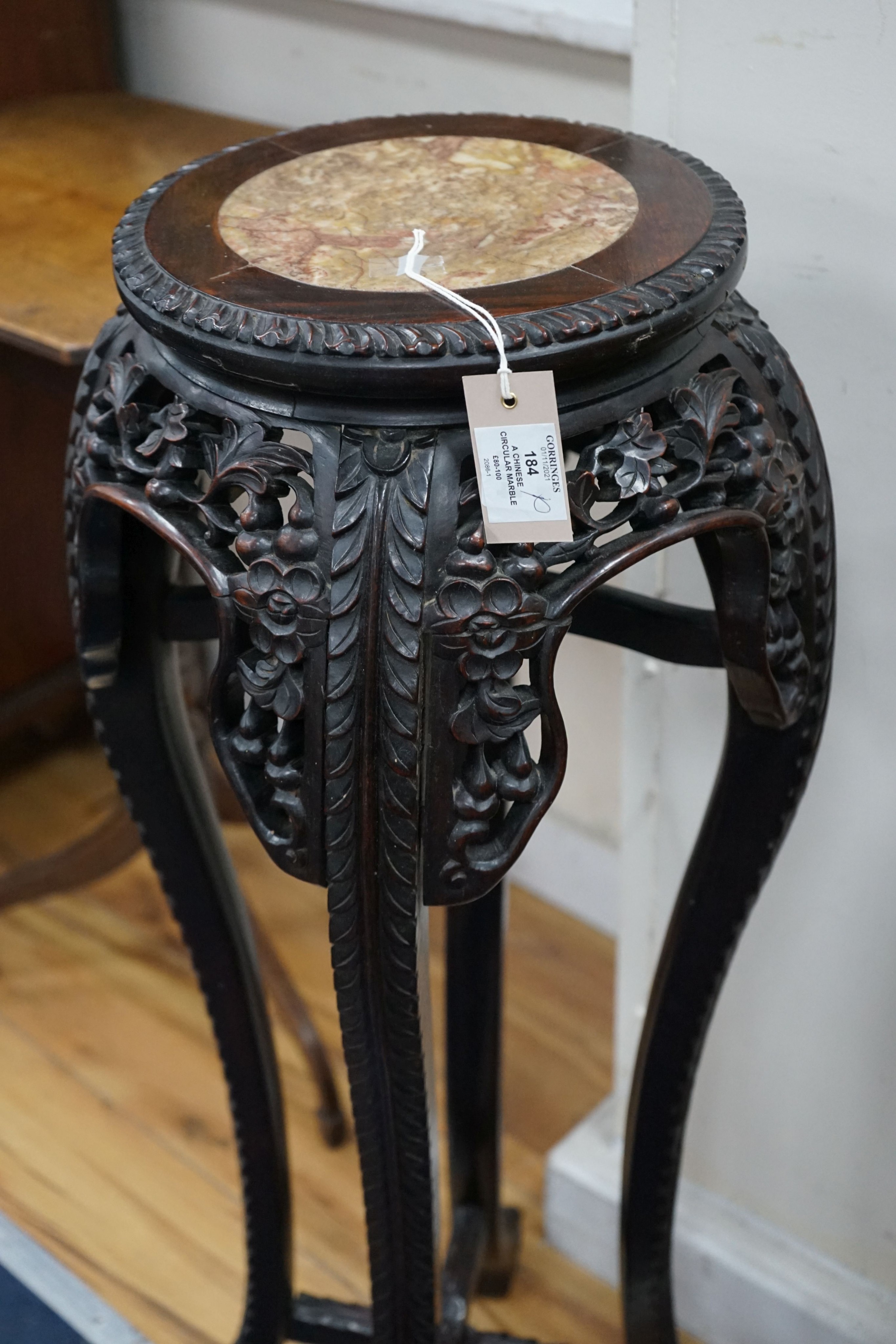 A Chinese circular marble top carved padouk jardiniere stand, height 91cm